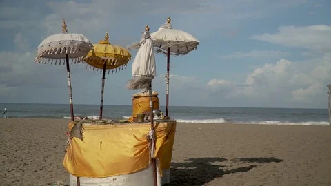 Bali, on the beach there is a table with parasols for offerings Stock Footage 126974042
