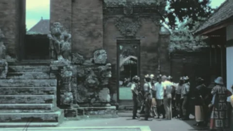 Bali, Indonesia - 1978: queue of people by sacred temple monument outdoors Video stock 229457189