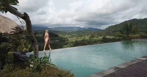 Bali Infinity Pool and Bikini Girl Drone Shot Stock Footage 106235853