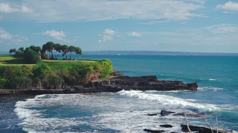 Bali landscape with ocean waves and rocky ledge with trees. Stock Footage 81216499