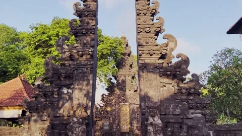 Bali Temple Split Gate with Volcanic Rock at Sacred Spiritual Site during Sunny Stock Footage 316896140