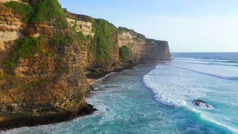 Bali - turquoise ocean hitting coral reef and rocky cliffs. Stock Footage 134621753