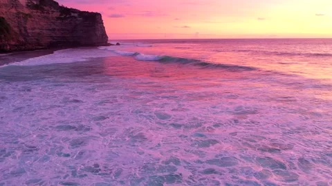 Bali - waves hitting coral reef and rocky cliffs. Sunset over the ocean. Stock Footage 134620037
