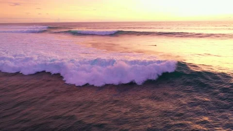 Bali - waves hitting coral reef and rocky cliffs. Sunset over the ocean. Stock Footage 134620236