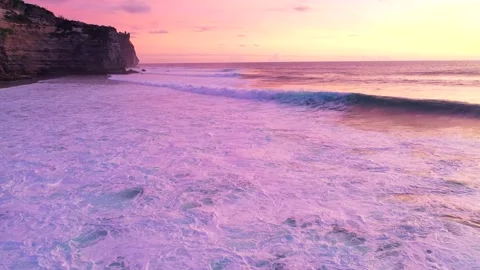 Bali - waves hitting coral reef and rocky cliffs. Sunset over the ocean. Stock Footage 134620253