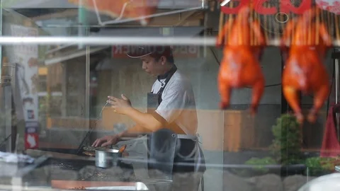 Balinese cook working in the kitchen Stock Footage 98450286