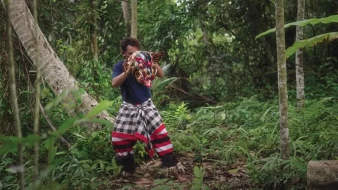 The Balinese dancer giggles when the Barong Bangkung mask breaks during Stock Footage 274635236