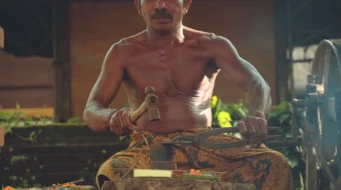 Balinese iron smith making tools traditional way in village, tilt up Stock Footage 68126005