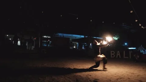 Balinese man performing fire dance on the beach at night Stock Footage 258746228