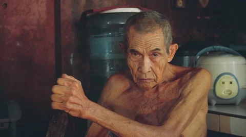 Balinese old man grating coconut in village kitchen, tripod Stock Footage 68115758