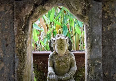 Balinese statue in a garden arch way Stock Photos