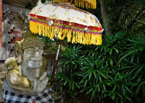 Balinese Stone Statue in a garden. Stock Photos