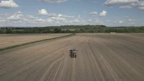 Baling machine in field go wheat, Derbyshire, England Stock Footage 205932227