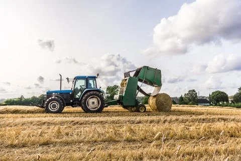 Baling Press Machine at work in a field Stock Photos