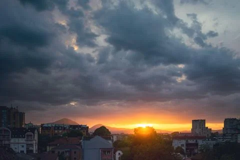Balkan city at sunset with dramatic sky Stock Photos