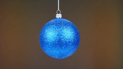 Ball on blue background. Silver New Year's toy rotates around its axis, macro ph Stock Footage 227721471