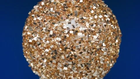 Ball on blue background. Silver New Year's toy rotates around its axis, macro ph Stock Footage 227723233