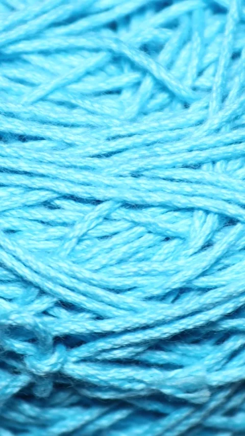 A ball of blue yarn sitting on a table, ready for knitting or crafting. Rot.. Stock Footage 344158634