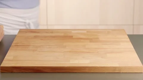 A ball of dough being rolled out on a work surface dusted with flour Video stock 24670102