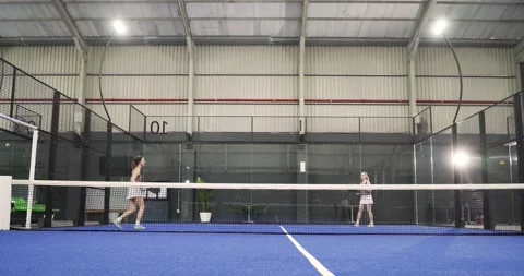 Ball feed machine starting Diverse female athletes rotating on court smashing Stock Footage 342018197