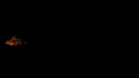 A ball of fire releasing from left of screen on an isolated black background Stock Footage 122187519