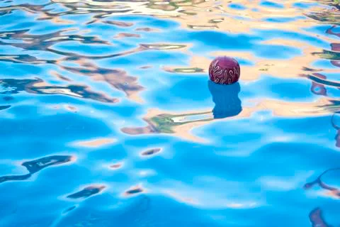 Ball floating in pool 写真素材