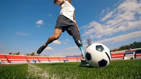 A ball is getting hit by an athlete with a bionic leg Stock Footage 116800698