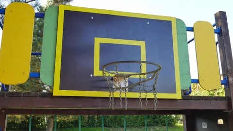 Ball going through basket hoop in school basketball court. Basketball falls thro Stock Footage