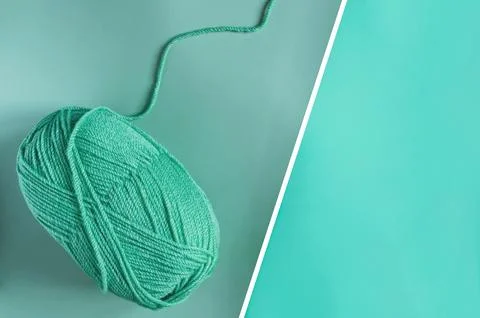 A ball of green threads on a two-tone green. Stock Photos