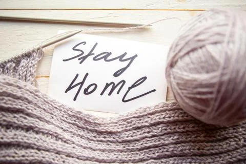 Ball of grey thread, knitting and card with message Stary Home on wooden back Stock Photos