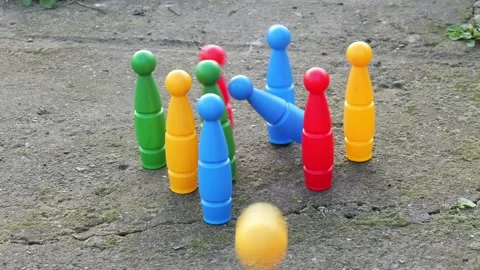 Ball hits and knocks down kids bowling pins slow motion Stock Footage 332725327