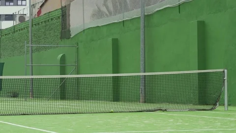 Ball hits net during match between two young male tennis players Stock Footage 172325868