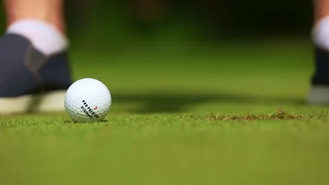 Ball hitting, close-up, a man playing golf and hammering the ball into the hole Видео 166523075