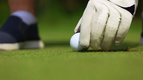 Ball hitting, close-up, a man playing golf and hammering the ball into the hole Video stock 166523193