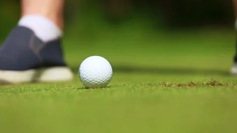 Ball hitting, close-up, a man playing golf and hammering the ball into the hole Video stock 169012228