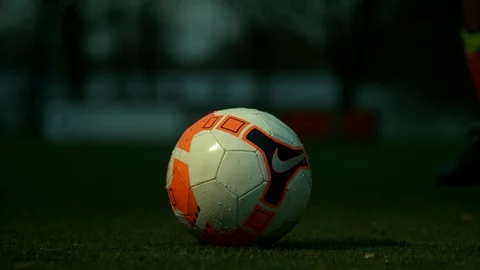 Ball lying on the ground gets kicked by the football player 4K 1000FPS Video stock 90953957