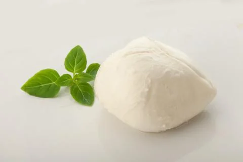 Ball of mozzarella with basil Stock Photos