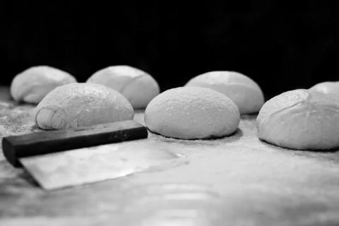 Ball of pizza dough on table with dusting of flour. Stock Photos