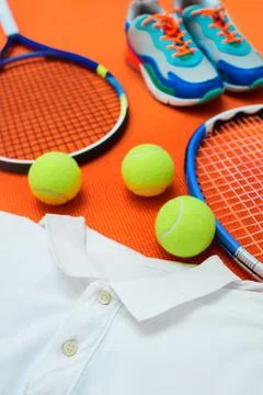 Ball, racket and clothes in studio for tennis competition, match or fitness Stock Photos