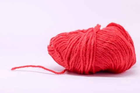 A ball of red wool in white background. Stock Photos