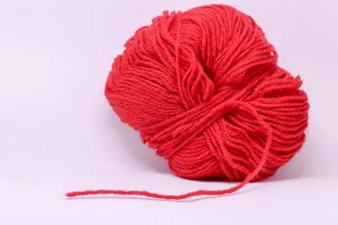 A ball of red wool in white background. Stock Photos