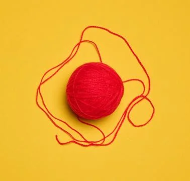Ball of red woolen thread on yellow background, top view Stock Illustration