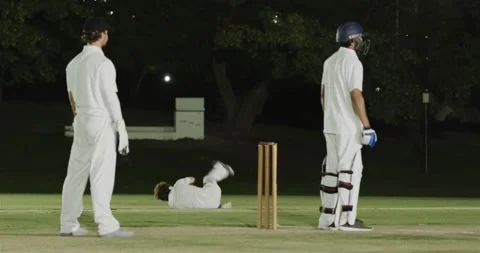 Ball release causing Indian bowler tumbling, recovering ball, running and Stock Footage 341664576