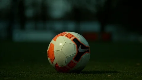 Ball revolves around on a grass field and a blurred background 4K 1000FPS Video stock 90954276