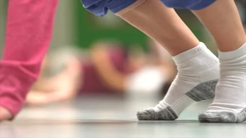 The ball rolls on the dance floor on the background of moving feet. impro dance. Stock Footage 147502960