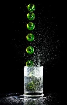 Ball sequence falling into a water glash Stock Photos