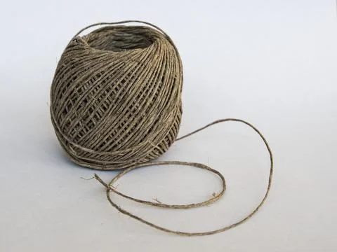 A ball of string made of natural hemp on a white background Foto stock