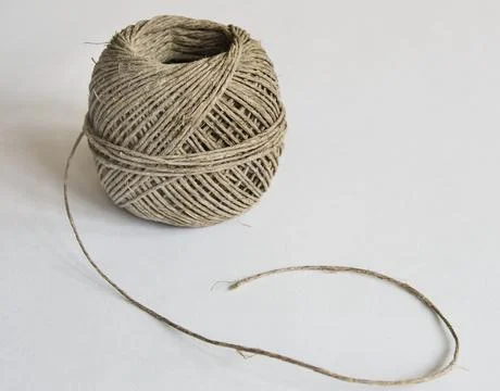 A ball of string made of natural hemp on a white background Stock Photos