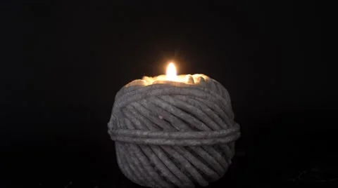 Ball of string shape candle burning Stock Footage 48950939