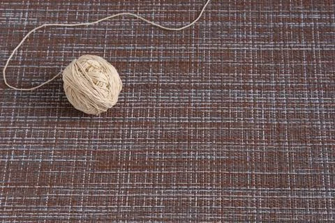 A ball with thick threads on the table. Stock Photos